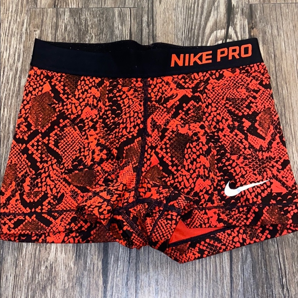 Red patterned Nike pros.